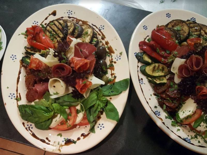 Antipasti platter with grilled vegetables and ham