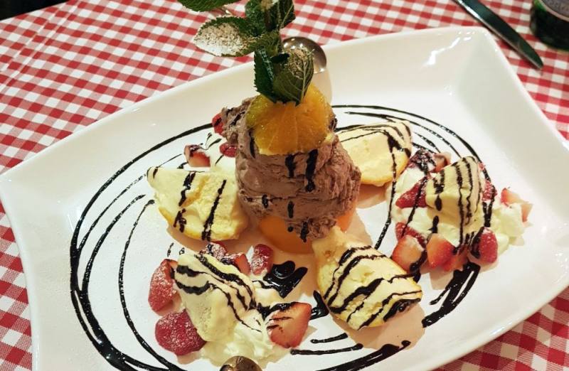 Dessert with ice cream, cream and fruit