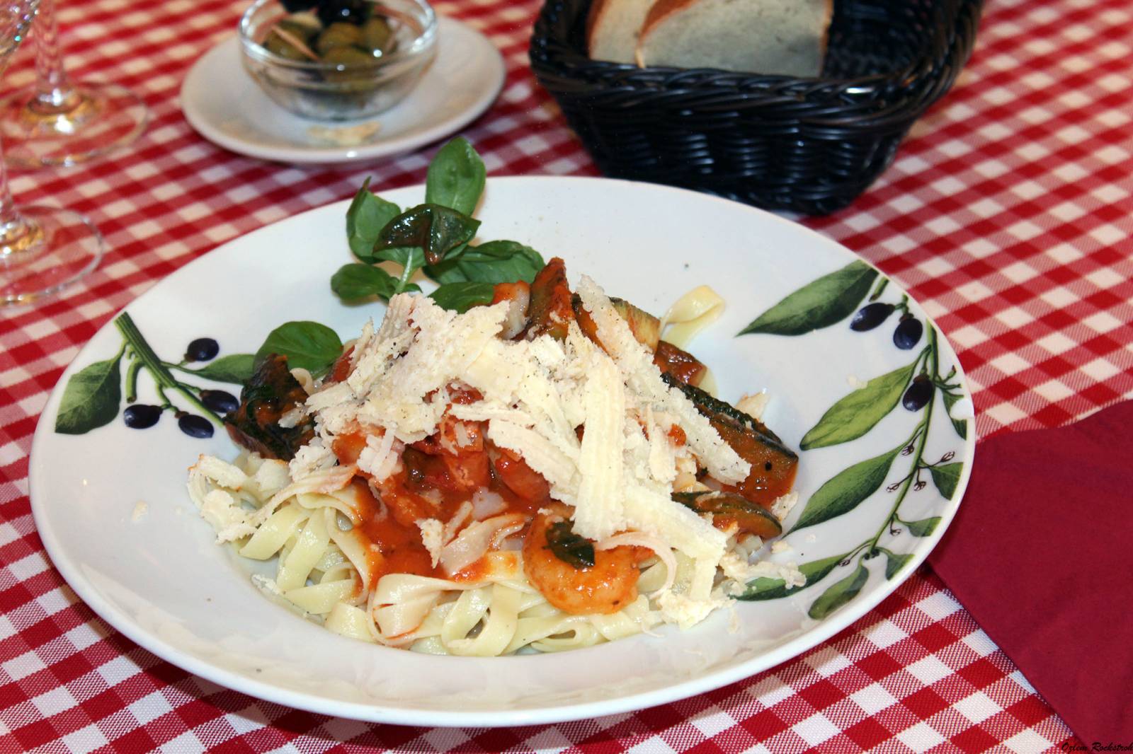 Tagliatelle with scampi on a red and white checked tablecloth